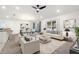 Spacious living room with light colored furniture and large windows at 3946 Postmark Lake Pl, Seffner, FL 33584