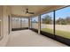 Screened porch with ceiling fan and view of backyard at 3946 Postmark Lake Pl, Seffner, FL 33584