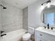 Updated bathroom, grey tile shower/tub combo, white vanity at 4039 Eastridge Dr, Valrico, FL 33596