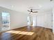 Sunny bedroom with wood-look floors and ceiling fan at 4039 Eastridge Dr, Valrico, FL 33596