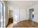Bedroom with wood-look floors and access to a bathroom at 4039 Eastridge Dr, Valrico, FL 33596