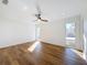 Bright bedroom with wood-look floors, dual windows, and ceiling fan at 4039 Eastridge Dr, Valrico, FL 33596