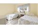 Guest bedroom with two twin beds and window at 6219 Palma Del Mar S Blvd # 114, St Petersburg, FL 33715