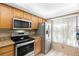 Kitchen boasts stainless steel appliances and wood cabinets at 6219 Palma Del Mar S Blvd # 114, St Petersburg, FL 33715