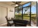 Relaxing lanai with wicker furniture offering scenic views at 6219 Palma Del Mar S Blvd # 114, St Petersburg, FL 33715