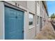 Teal door condo building exterior, showcasing a walkway and building number at 6311 Newtown Cir # 11B1, Tampa, FL 33615