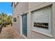 Teal door condo building exterior, showcasing a walkway and building number at 6311 Newtown Cir # 11B1, Tampa, FL 33615