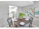 Modern dining area with a round table and gray chairs at 6311 Newtown Cir # 11B1, Tampa, FL 33615