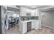 Kitchen features white cabinets and a wine rack at 6311 Newtown Cir # 11B1, Tampa, FL 33615