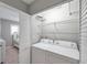 Bright laundry room with washer, dryer, and ample shelving at 6311 Newtown Cir # 11B1, Tampa, FL 33615