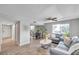 Bright living room with gray sofa, coffee table, and dining area at 6311 Newtown Cir # 11B1, Tampa, FL 33615