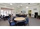 Community room with tables, chairs, and comfortable seating areas at 6363 99Th N Way # 12A, St Petersburg, FL 33708