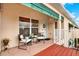 Inviting entryway with a red-stained deck and seating area, creating a welcoming atmosphere at 6363 99Th N Way # 12A, St Petersburg, FL 33708