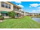 Back exterior view showing a building with private patios and lush landscaping at 6363 99Th N Way # 12A, St Petersburg, FL 33708