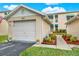 Attached garage with driveway and landscaping at 6363 99Th N Way # 12A, St Petersburg, FL 33708