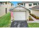 Attached garage with driveway and landscaping at 6363 99Th N Way # 12A, St Petersburg, FL 33708