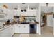 White kitchen with black appliances and water views at 6363 99Th N Way # 12A, St Petersburg, FL 33708