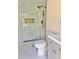 Bathroom with marble-look shower with glass door, gray vanity, and modern toilet at 6615 Parkside Dr, New Port Richey, FL 34653