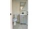 Bathroom showcasing gray vanity, modern toilet, and marble-look floors at 6615 Parkside Dr, New Port Richey, FL 34653
