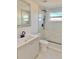 Bathroom showcasing gray vanity, modern toilet, and marble-look shower at 6615 Parkside Dr, New Port Richey, FL 34653
