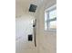 Modern bathroom features a rain shower head, hand shower, and marble-look tile walls at 6615 Parkside Dr, New Port Richey, FL 34653