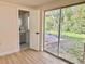 Bedroom with wood floors, a sliding glass door and an ensuite bathroom at 6615 Parkside Dr, New Port Richey, FL 34653