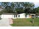 Charming single-story home featuring a freshly painted exterior, well-kept lawn, and mature trees at 6615 Parkside Dr, New Port Richey, FL 34653