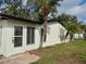 Side view of a freshly painted home with palm trees and a well-kept lawn at 6615 Parkside Dr, New Port Richey, FL 34653