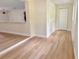 Hallway features wood-look flooring leading to a closet and other rooms in the house at 6615 Parkside Dr, New Port Richey, FL 34653