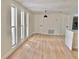 Bright living room featuring new flooring, fresh paint, and ample natural light at 6615 Parkside Dr, New Port Richey, FL 34653