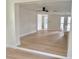 Open-concept living room and kitchen with light wood floors and modern finishes at 6615 Parkside Dr, New Port Richey, FL 34653