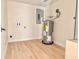 Utility room with wood-look floors, washer/dryer hookups, and water heater at 6615 Parkside Dr, New Port Richey, FL 34653