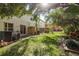 Green grassy backyard with mature trees and privacy at 8907 Casablanca Way, Tampa, FL 33626