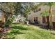 Large backyard with lush grass and mature trees at 8907 Casablanca Way, Tampa, FL 33626