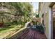 Spacious backyard with a wooden deck and lush greenery at 8907 Casablanca Way, Tampa, FL 33626