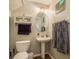 Small bathroom with pedestal sink, oval mirror, and neutral color palette at 8907 Casablanca Way, Tampa, FL 33626