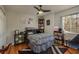 Cozy bedroom with wood floors, ceiling fan, and built in shelving at 8907 Casablanca Way, Tampa, FL 33626
