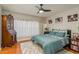 Spacious bedroom with wood floors, ceiling fan, and large windows at 8907 Casablanca Way, Tampa, FL 33626