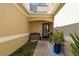Front entry with a bench and potted plants at 8907 Casablanca Way, Tampa, FL 33626