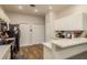 White kitchen features recessed lighting, stainless steel appliances, and hardwood floors at 8907 Casablanca Way, Tampa, FL 33626