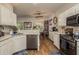 Open concept kitchen boasts stainless steel appliances and hardwood floors at 8907 Casablanca Way, Tampa, FL 33626