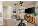 Living room with gray couches, wood floors, and a large TV at 8907 Casablanca Way, Tampa, FL 33626