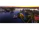 Waterfront home at dusk with city views in the background at 930 Monterey Ne Pt, St Petersburg, FL 33704