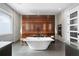 Spa-like bathroom with a freestanding tub and a large wood feature wall at 930 Monterey Ne Pt, St Petersburg, FL 33704