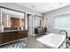 Bathroom with double vanity, freestanding tub, and a large window at 930 Monterey Ne Pt, St Petersburg, FL 33704