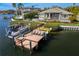 Private dock with boat lift and seating area at 930 Monterey Ne Pt, St Petersburg, FL 33704