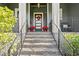 Front entrance with stone steps and modern railings at 930 Monterey Ne Pt, St Petersburg, FL 33704