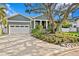 Gray house with white garage and landscaping at 930 Monterey Ne Pt, St Petersburg, FL 33704