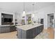 Modern kitchen features white cabinets, black island, and a large range hood at 930 Monterey Ne Pt, St Petersburg, FL 33704