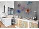 Modern kitchen features white cabinets, quartz countertops, wine cooler, and decorative wall art at 930 Monterey Ne Pt, St Petersburg, FL 33704